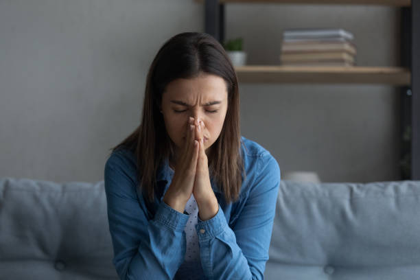 istock Close up unhappy desperate woman praying at home, asking help 1309798027