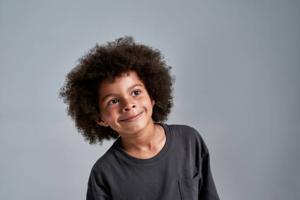 istock Little african american boy looking to side and smiling 1309798876