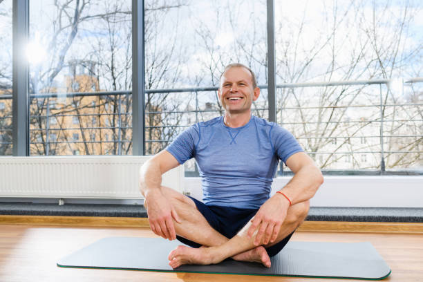 istock Smiling aged man sit on sport mat 1309798983