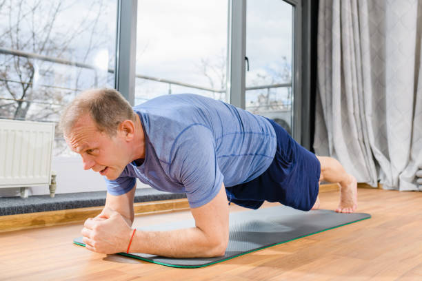 istock Mature sport man stay in plank position 1309799124