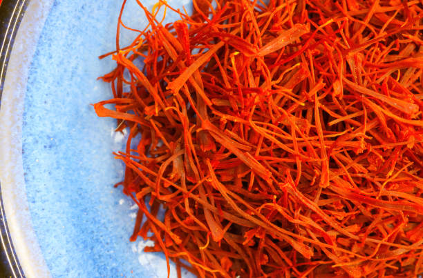 istock Makro closeup of isolated red dried saffron threads on blue plate 1309799410