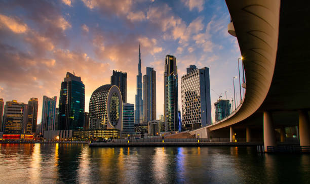 Aerial skyline of downtown Dubai filled with modern skyscrapers in the UAE Aerial skyline panorama of downtown Dubai filled with modern skyscrapers in the United Arab Emirates rising above the main city highway aerial view at sunrise dubai stock pictures, royalty-free photos & images