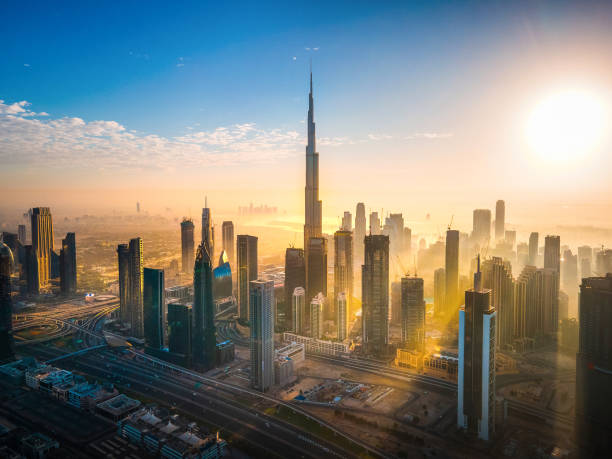 Aerial skyline of downtown Dubai filled with modern skyscrapers in the UAE Aerial skyline of downtown Dubai filled with modern skyscrapers in the United Arab Emirates rising above the main city highway aerial view at sunrise dubai stock pictures, royalty-free photos & images