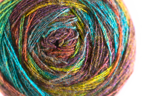 Knitting and crocheting. Multi-color skein of natural wool yarn. Thread