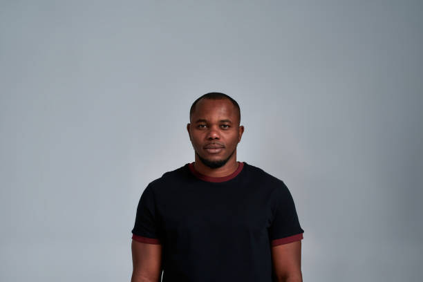 istock Cheerful young african american man on light background 1309801472