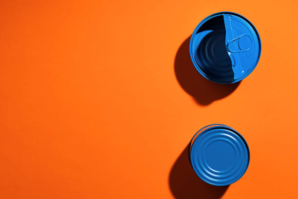istock Aesthetic concept with blue painted tin can on orange background 1309802151