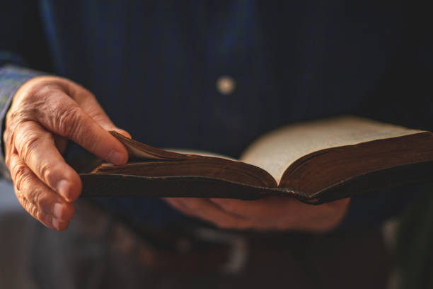 Old Bible in hands of an old man