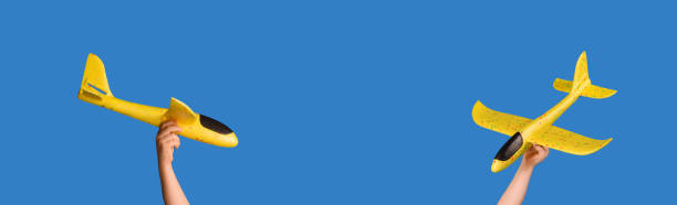 istock Yellow toy plane on a blue background. Traveling concept. 1309803630