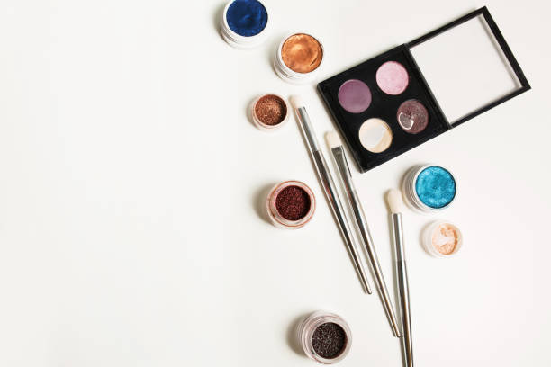 istock Palette of eyeshadow, eye pigment and brushes on a white background. Empty space 1309804053