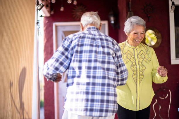 istock Senior Mexican Couple Dancing at Home 1309804088