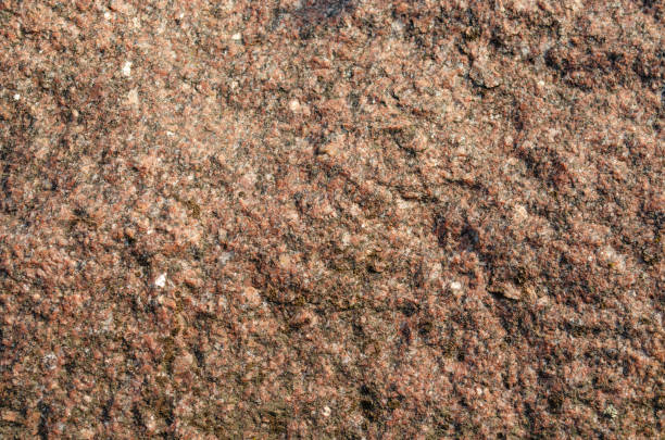 istock Red black white granite natural texture background. Embossed surface with shadows and stone chips 1309804166