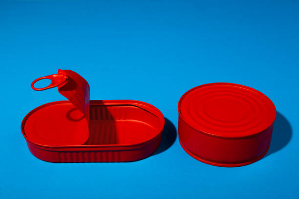 istock Red tin can on blue background close up 1309805220