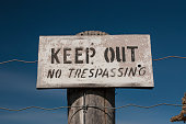 A Faded Warning Sign Reads - Keep Out No Trespassing