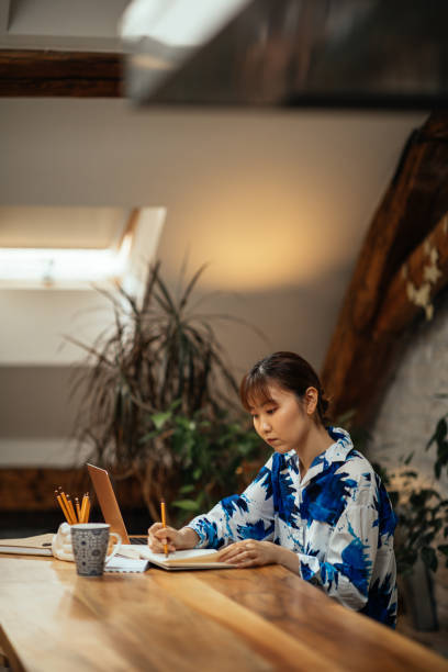 istock Japanese woman working at home and taking notes 1309809013