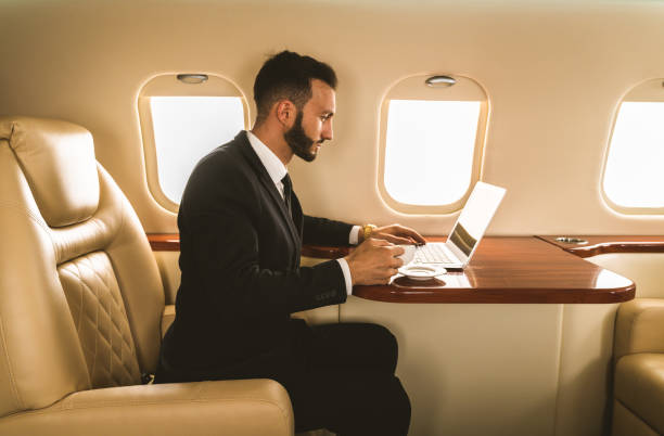 istock Businessman flying on private jet 1309809441