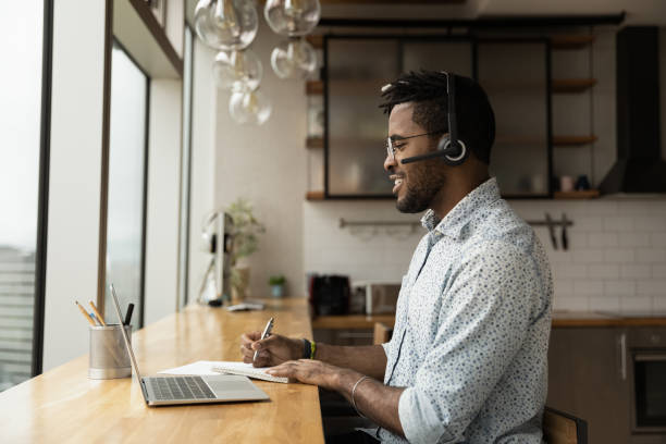 istock Side view confident African American man wearing headphones taking notes 1309809639