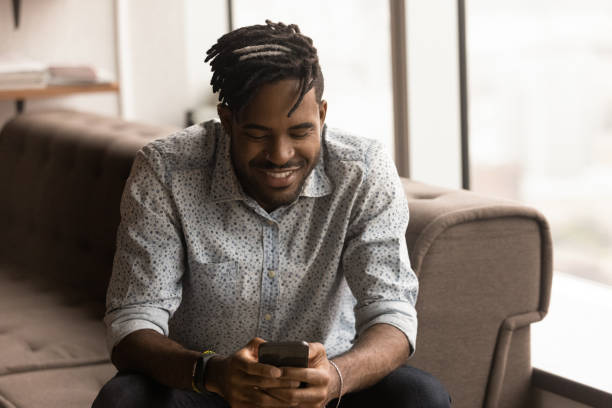 istock Close up smiling African American man holding phone, browsing apps 1309810189