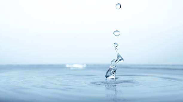istock water drop splash in a glass blue colored 1309811998