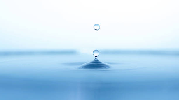 istock water drop splash in a glass blue colored 1309812621