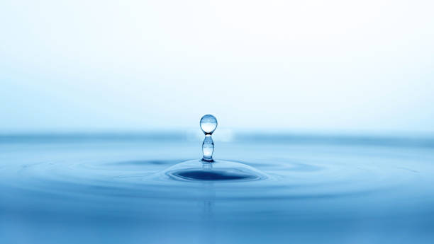 istock water drop splash in a glass blue colored 1309812643