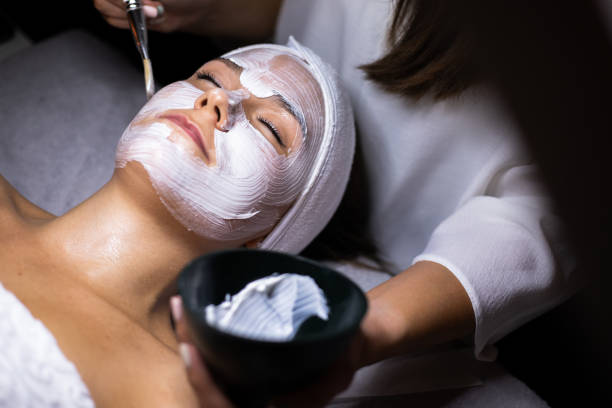 istock Beautician applying face mask with a brush 1309814102