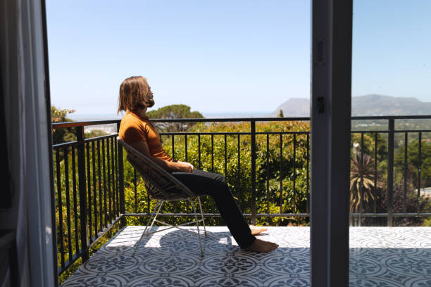 istock Caucasian man sitting on balcony looking away 1309814706