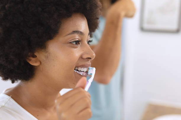 istock Diverse couple standing in bathroom brushing teeth 1309815422