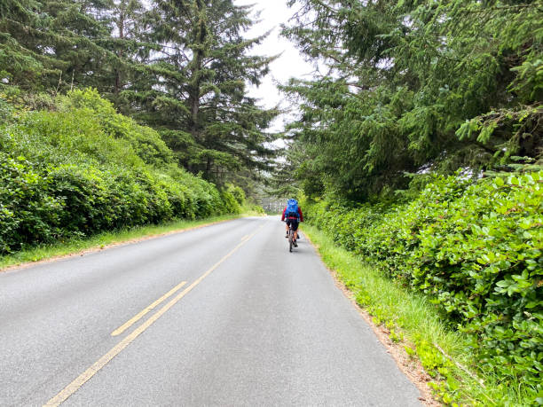 father and son ride bikes together in oregon - people strength leadership remote imagens e fotografias de stock