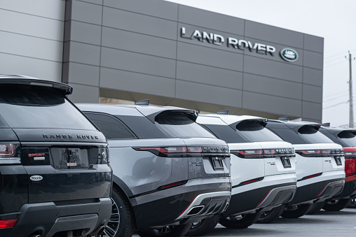 Halifax, Canada - March 28, 2021 - A line of 2021 Range Rover Sport & Velar sport utility vehicles at a Land Rover dealership. Focus on background sign.