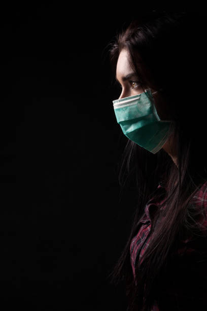istock Girl in a green protective mask 1309818269