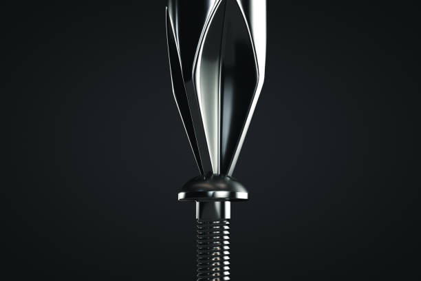 Tighten the screw with a screwdriver. Close-up. Dark background.