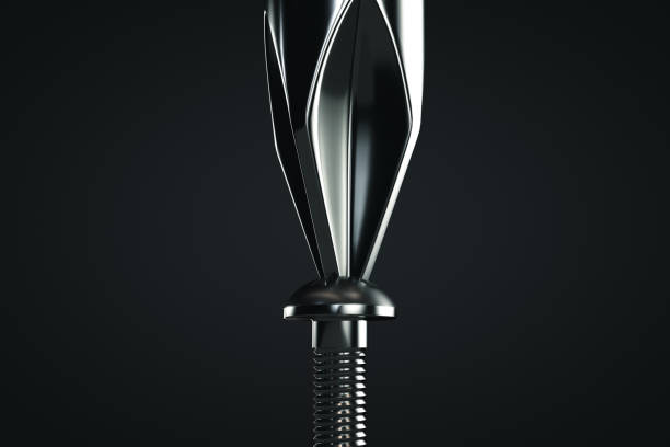 Tighten the screw with a screwdriver. Close-up. Dark background. Tighten the screw with a screwdriver. Close-up. Dark background screwdriver photos stock pictures, royalty-free photos & images
