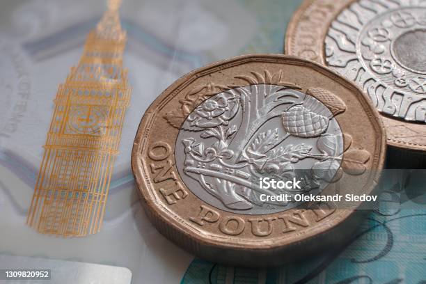 British One Pound Coin Placed On Top Of Polymer 5 Pound Banknote With Visible Big Ben Symbol Stock Photo - Download Image Now