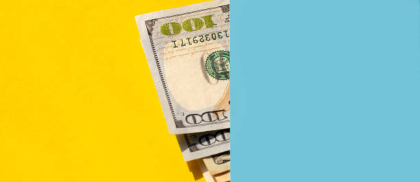 istock dollar bills on a yellow - blue background. Business concept. 1309822612
