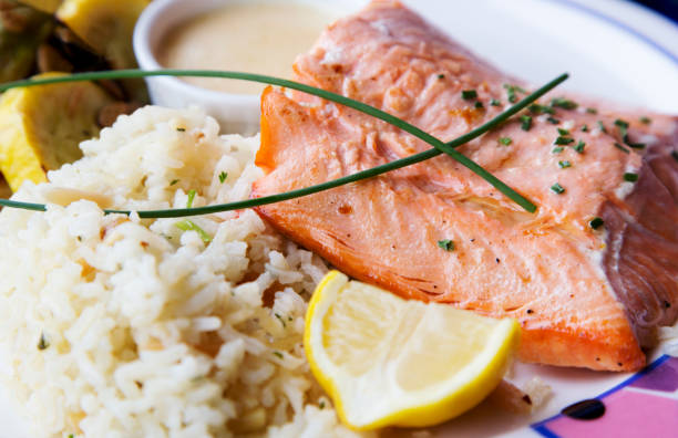 istock Fresh salmon fillet with rice pilaf accented with lemon and scallion 1309822692