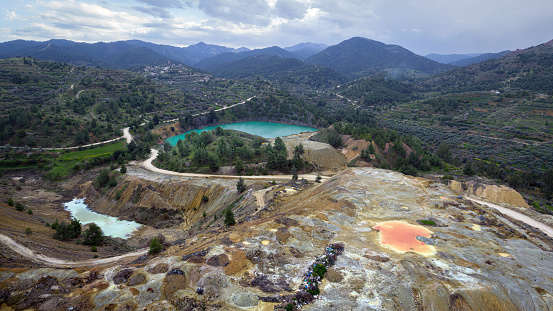 Multicolored waste rocks and tailings from mining near abandoned open pit Memi mine in Xyliatos, Cyprus. This area is rich with copper and sulphide deposits