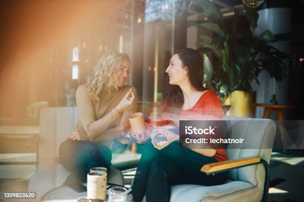 Female Friends Relaxing In The Cafe Stock Photo - Download Image Now - Adult, Adults Only, Bar - Drink Establishment