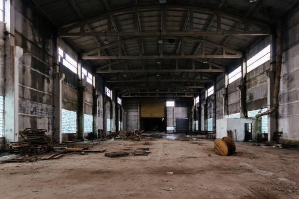 istock Abandoned ruined large industrial hall with garbage waiting for demolition 1309829029