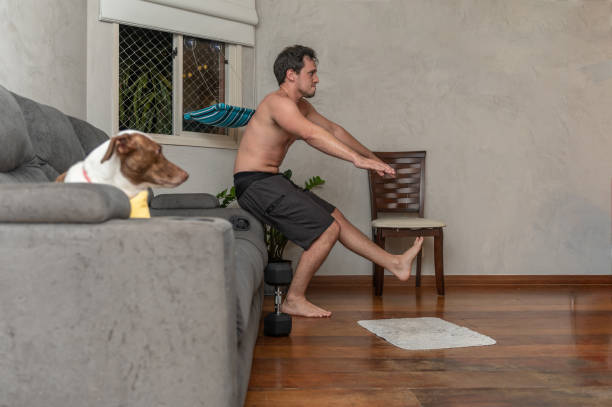 istock young man exercising at home 1309833346