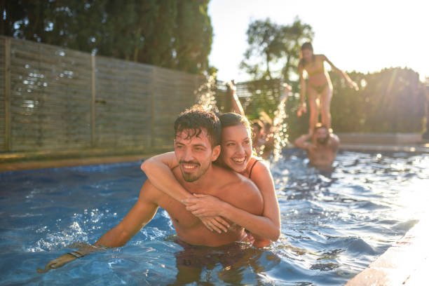 istock Relaxed Spanish Friends in 20s and 30s Playing in Pool 1309835946
