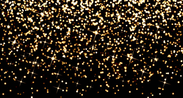 istock Glowing gold bokeh background on black 1309836590