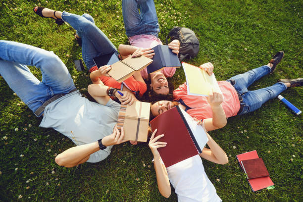 istock Young people are laughing while lying on the grass 1309841209