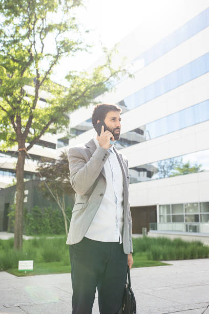 istock Businessman talking on a mobile phone in a business district 1309841316