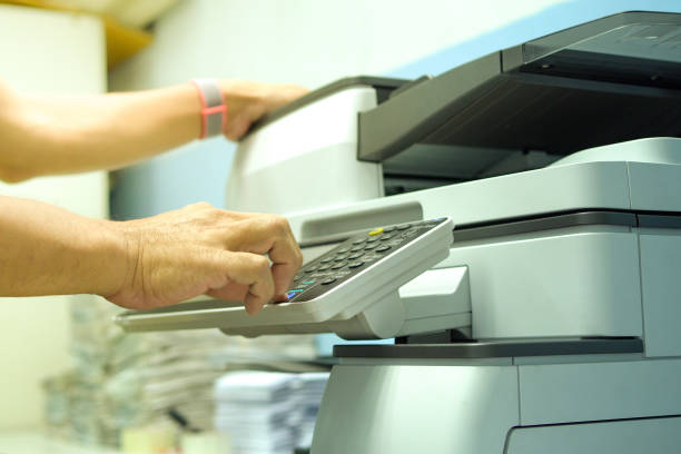 istock Hand of man is pressing the start button to using a photocopier to copy document. 1309842206