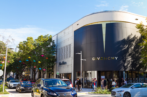 Miami, Florida, USA - December 26, 2020: A landscape view of Givenchy building store in Miami Design District in a blue winter day.\n\nThe Design District, is a neighborhood within the city of Miami, Florida, United States, USA home of many flagship luxury stores including Tom Ford, Hermès, Louis Vuitton, Christian Louboutin, Prada, Celine and much more. An Art Neighborhood in Miami Florida which has a strong art culture presence and murals can be seen everywhere. Many stores was affected by Corona Virus Pandemic Illness and closed their business.
