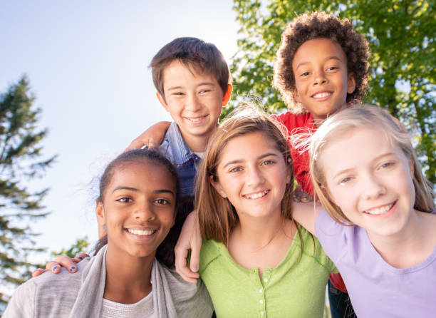 istock Happy Children Posing For A Photo While Outdoors On A Summer Day 1309844574