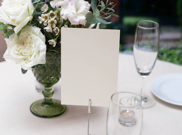 istock Mockup white blank space card, for greeting, table number, wedding invitation template on wedding table background. with clipping path 1309844652