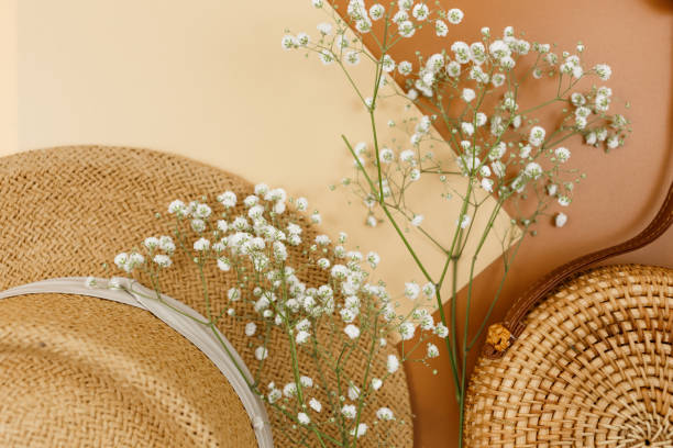istock Tropical straw hat, bag, summer flowers on beige brown background. Trendy tropical pattern. Fashion clothing and accessories. Flat lay. Summer, vacation, holidays concept. 1309847055