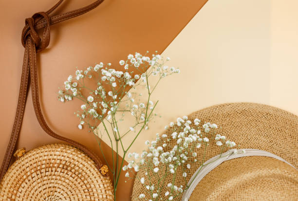 istock Tropical straw hat, bag, summer flowers on beige brown background. Trendy tropical pattern. Fashion clothing and accessories. Flat lay. Summer, vacation, holidays concept. 1309847062