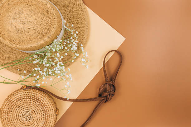istock Tropical straw hat, bag, summer flowers on beige brown background. Trendy tropical pattern. Fashion clothing and accessories. Flat lay. Summer, vacation, holidays concept. 1309847088